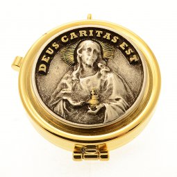 Copertina di 'Teca eucaristica porta ostie con placca bronzata in rilievo "Deus caritas est" - diametro 5,3 cm'